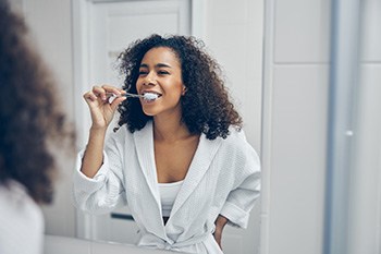 Invisalign Patient in Portage brushing their teeth