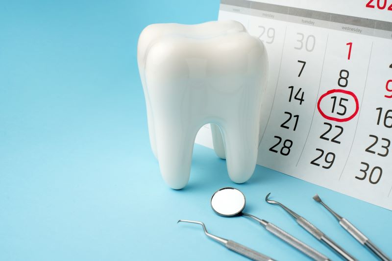 calendar with reminder to visit dentist and toothbrush